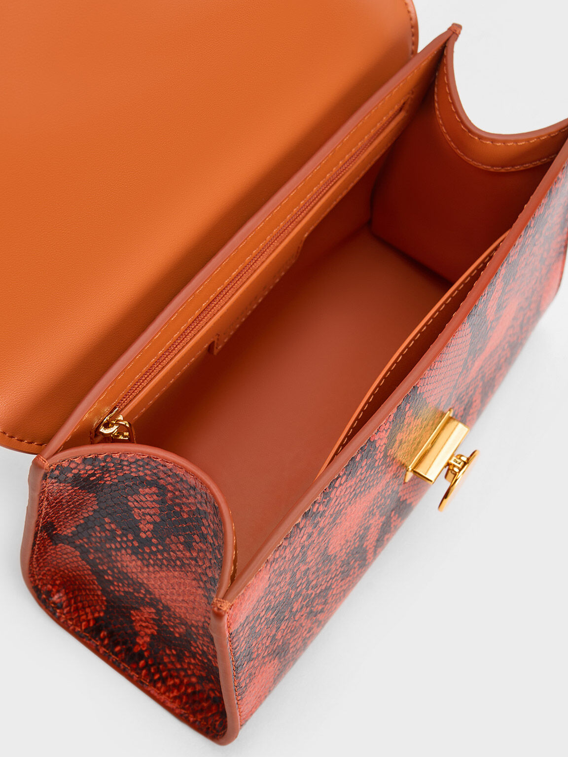 Orange snake print clutch bag store