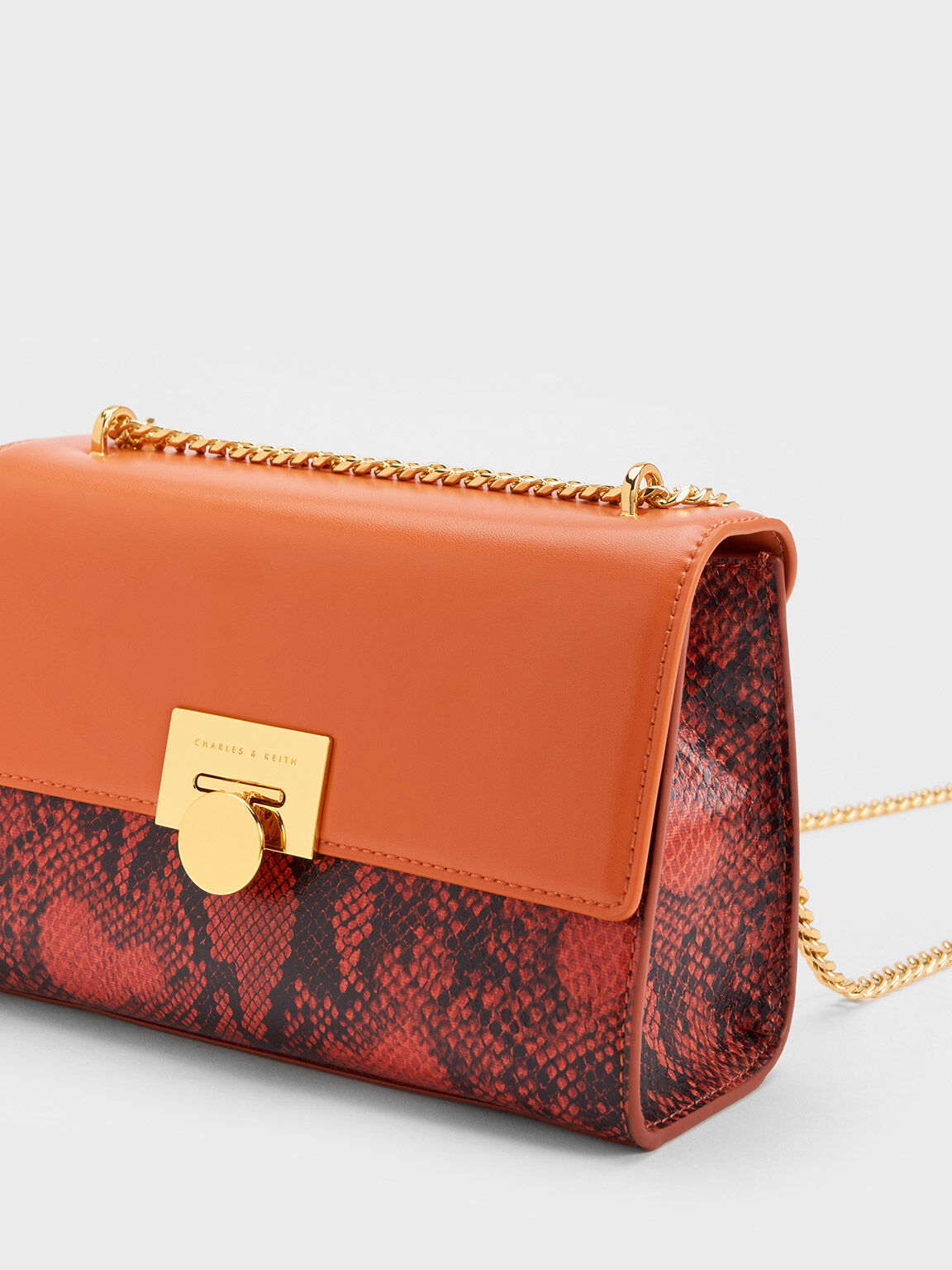 Orange snake print online clutch bag